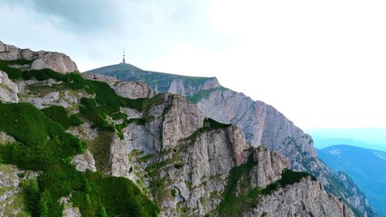 Stunning mountain view in Busteni Romania by cable car. Scenic view of rocky cliffs and lush greenery in Busteni, Romania, showcasing the beauty of the surrounding mountains.