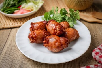 Fried Isaan sausages in a white plate ,Thai called sai krok isan