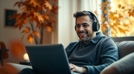 Smiling man wear headphones talk video calling, communicating with clients, using laptop, watching webinar or video stream conference, remote work from home. Distance education
