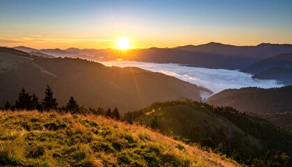 Golden sunrise over misty mountain valley with vibrant sky.