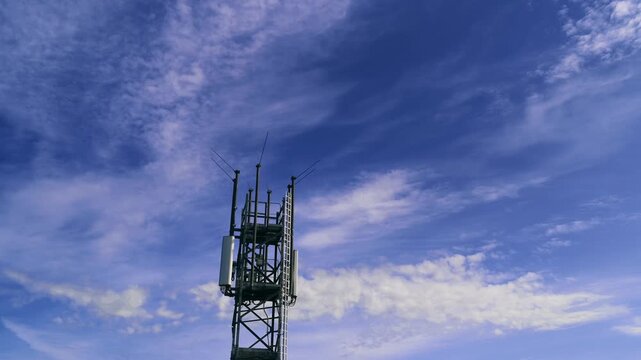 Ein Funkmast vor blauem Himmel mit Wolken