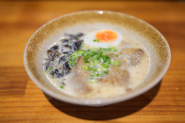 Ramen noodles served in bowl on table in Japanese restaurant