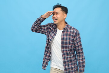 Side view of young Asian man wearing casual clothes, looking into the distance, hand gesture on...