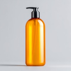 A tall amber colored pump bottle with a black dispenser cap on a light grey background