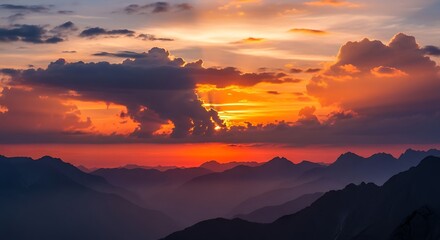 Dramatic sunset panorama over a mountain range, showcasing vibrant colors and dramatic clouds.