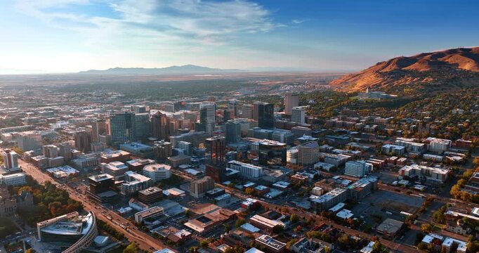 Modern urban landscape around the beautiful rocks. Neighborhoods of Salt Lake City, Utah, USA at sunset.