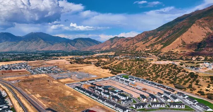 Spanish Fork city in the Utah Valley, Utah, USA. Dramatic clouds hang over the mountains at backdrop.