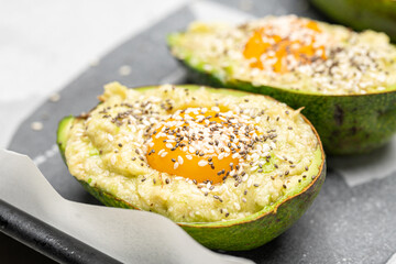 Baked Avocado with Egg and Sesame Seeds Ready for Oven