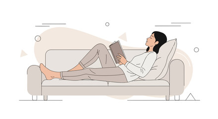 Woman Comfortably Reclines on a Couch While Reading a Book for Relaxation
