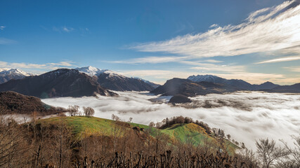 Fog in the valley under the hills and mountains