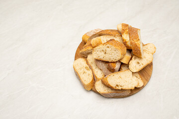 Top View of Sliced French Bread on Wooden Cutting Board with Copy Space