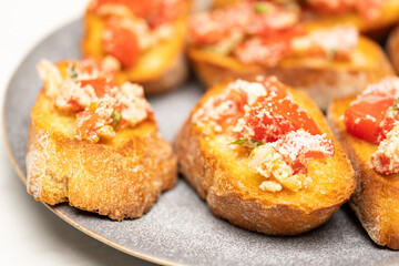 Delicious Baguette Appetizer with Cheese, Tomato and Spices on Plate