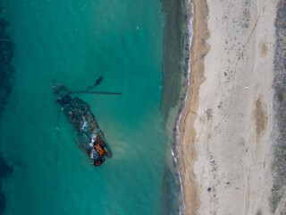 Aerial top down of wrecked boat Mediterranean Sea view from shipwreck near Thessaloniki