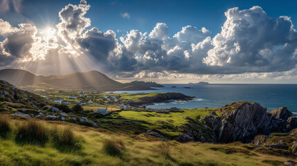 Sunlight breaks through clouds over a coastal village with green fields, rocky cliffs, and the sea. The rural landscape is dominated by open spaces and distant mountains.