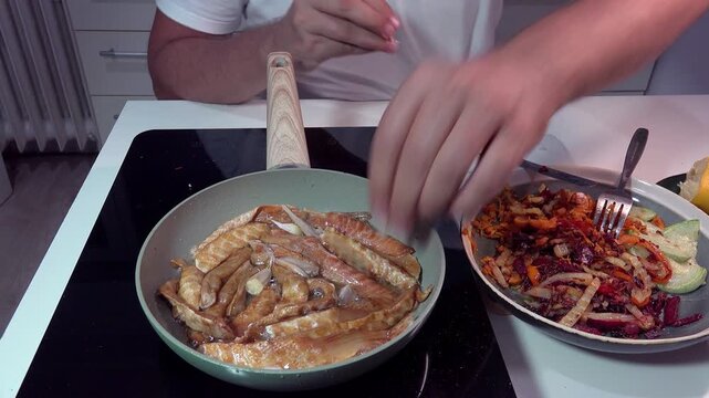 Preparing food in a pan, fish meat