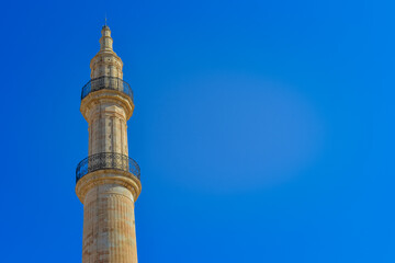 Greece, Rethimno, 05.09.2025: historic mosque minaret and domes under clear blue sky