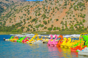 Greece, Crete, 07.09.2025: colorful pedal boats shaped like flamingos and ducks on Lake Kournas © Delia_Suvari