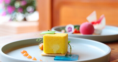 Gourmet dessert plate featuring colorful, modern pastry art in elegant restaurant setting, focusing on exquisite presentation and culinary design.