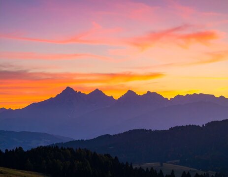Silhouetted mountain range at vibrant sunset - Powered by Adobe