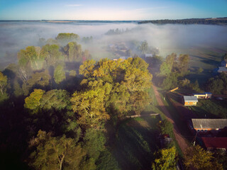 Aerial view landscape on foggy morning in countryside with lake and forest

