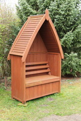 A Boat Shaped Wooden Garden Sheltered Seat.