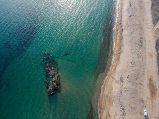 Aerial landscape of wrecked boat Mediterranean Sea sunset at shipwreck beach Thessaloniki
