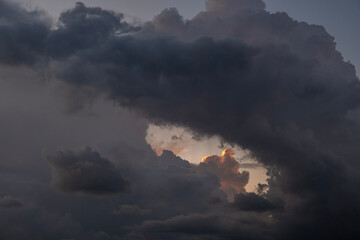 Big cumulus clouds over the sea at sunset