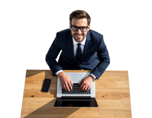 A confident businessman wearing glasses, smiling as he works on a laptop placed on a