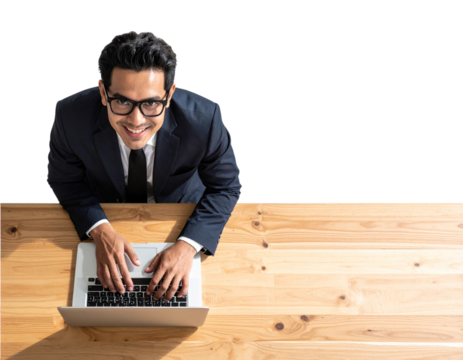A confident businessman wearing glasses, smiling as he works on a laptop placed on a - Powered by Adobe