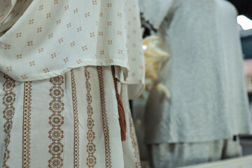 Close-up of a patterned cream-colored dress