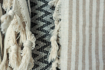Close-up of textured fabric with tassels and various patterns.
