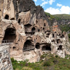 Ancient cave monastery complex carved into a hillside