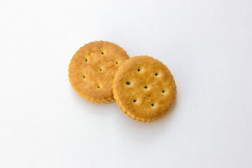 A golden brown biscuit on a white background.
