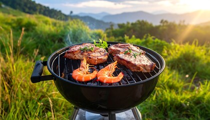 A close-up captures grilled steaks and shrimp on a black grill atop a hillside with distant mountains under a bright sun