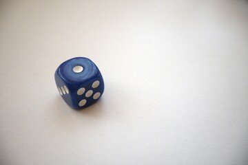 Single blue die showing one pip, isolated with copy space for design use.