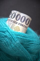 Hungarian 20000 forint banknote tied with green yarn, symbolizing the thread of life, wealth, fate,...