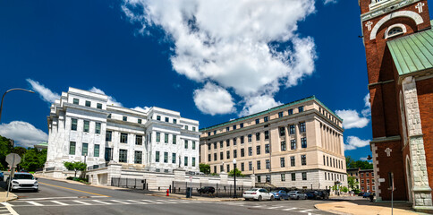 The white marble NY Court of Appeals and the Albany County Supreme Court buildings on a sunny day with a blue sky in downtown Albany, New York, USA