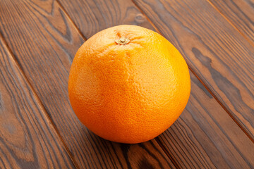 grapefruit on brown wood background