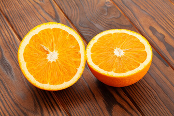 sliced oranges on brown wood background