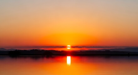 Obraz premium Vibrant Orange Sunset Over a Calm Ocean.