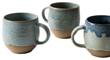 Collection of three handcrafted ceramic mugs showcasing a rustic two-tone design with earthy unglazed bottoms and beautiful blue-glazed tops, perfect for coffee or tea