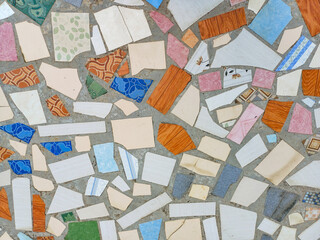 beautiful colorful mosaic floor made of broken ceramic tiles with abstract patterns. Ideal for texture background, recycled art, tile design, and creative surface concept.