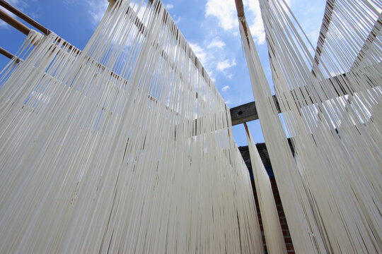 Handmade somen noodles, a traditional food from Huatan Township, Changhua County, Taiwan, are hung to dry in the sun.