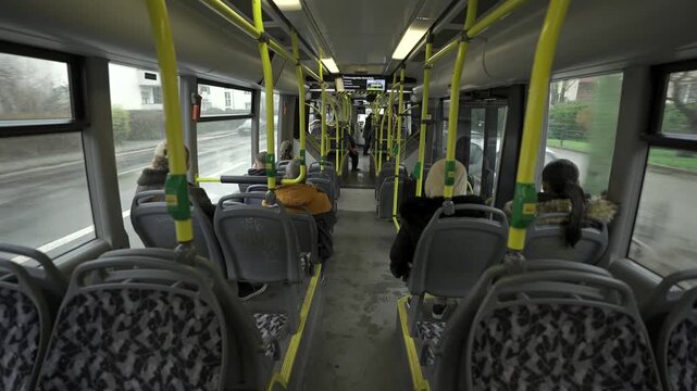 Germany, Berlin. Municipal bus BVG, Berliner Verkehrsbetriebe view from inside from passenger seat. Interior of yellow city bus on route in Berlin. Public transportation in Germany. 