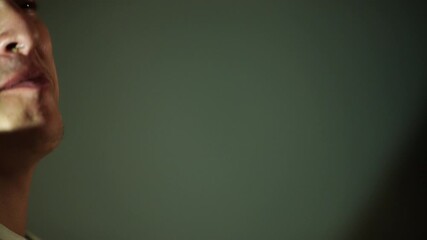 handsome man sings while playing an acoustic guitar