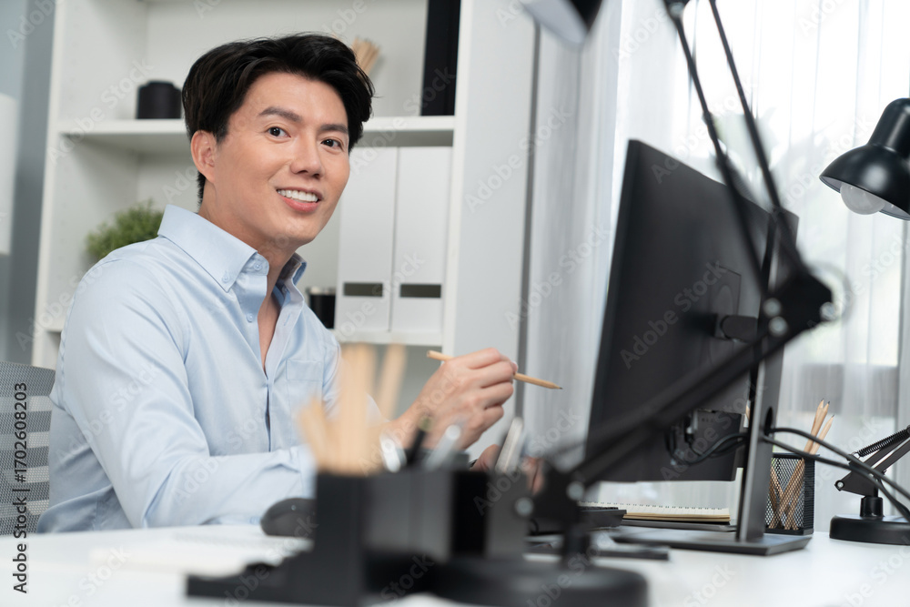 Poster portrait of smart businessman looking camera to pose while working on computer checking email wearin