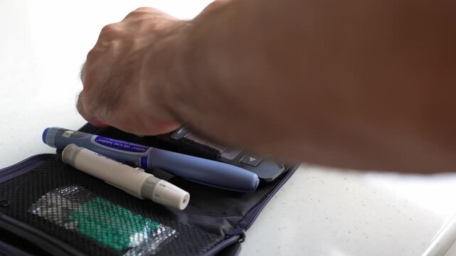  Men using glucometer for checking blood sugar level at home. 