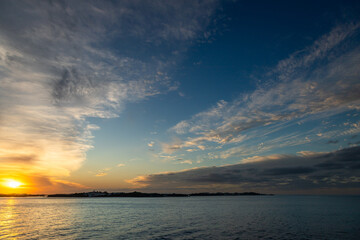 Obraz premium Golden Atlantic Ocean sunset with vivid clouds and calm waters. Ideal for travel ads, wellness branding, relaxation concepts, or nature and freedom-themed marketing visuals