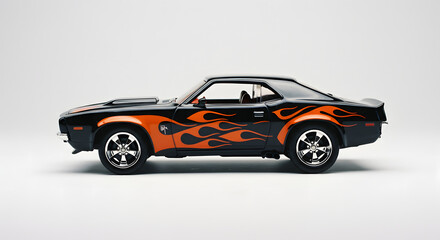 Collectible miniature black classic sports car with orange flames on white background