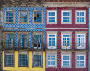 Traditional colorful facades with balconies in Porto, showcasing the charm of historic Portuguese architecture creating a rectangular pattern